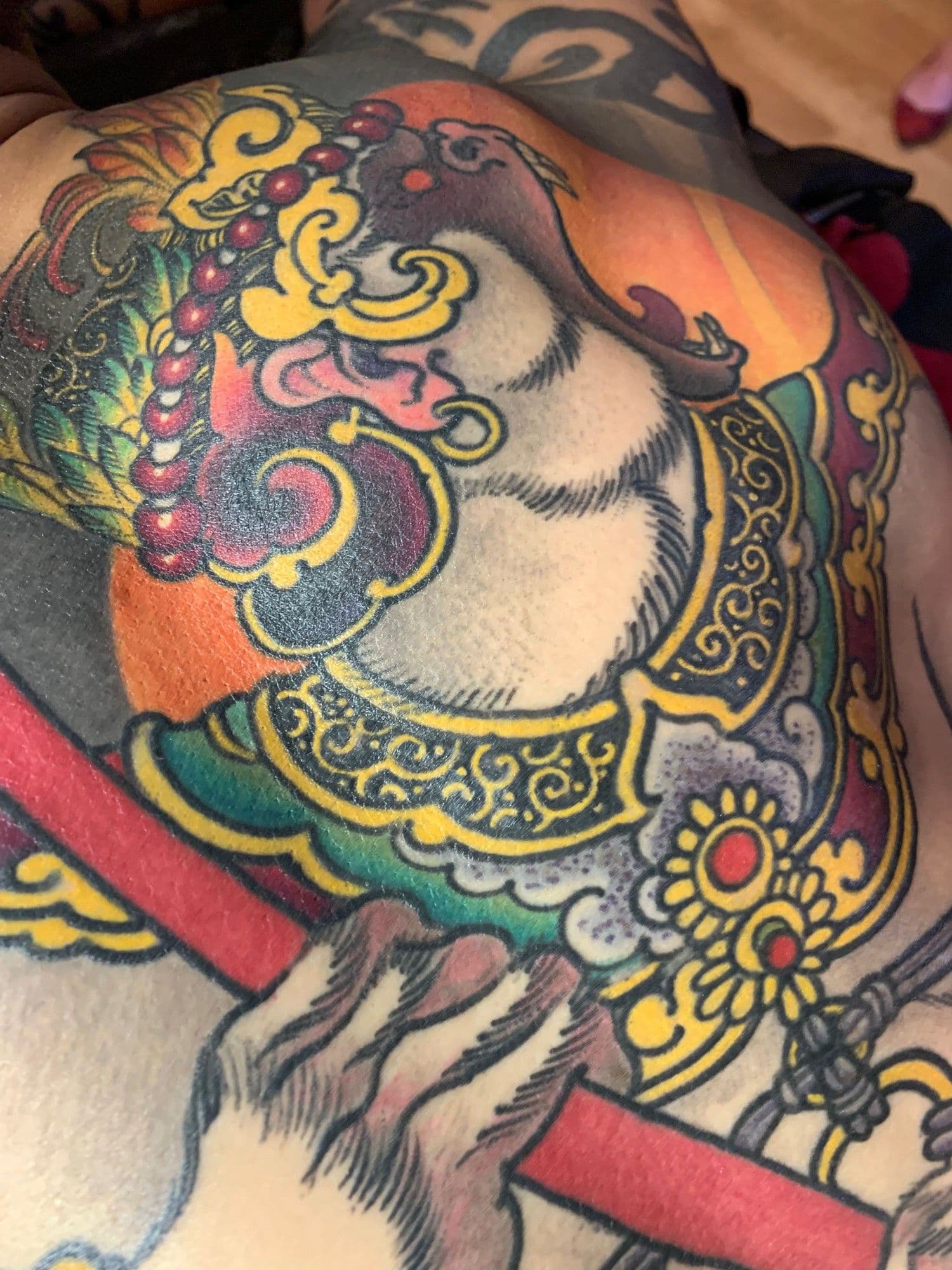 Close-up of a colorful tattoo featured in Jeff Gogue’s official artist listing.
